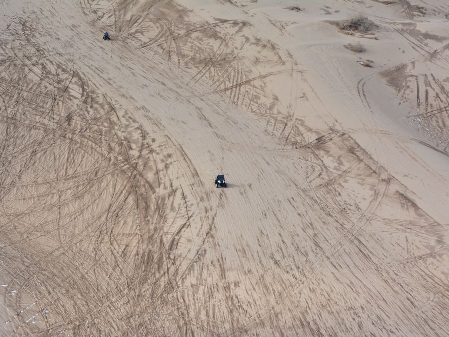 ATV riding over sand dunes